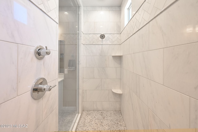 bathroom with a tile shower