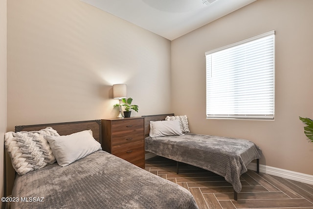 bedroom with visible vents and baseboards