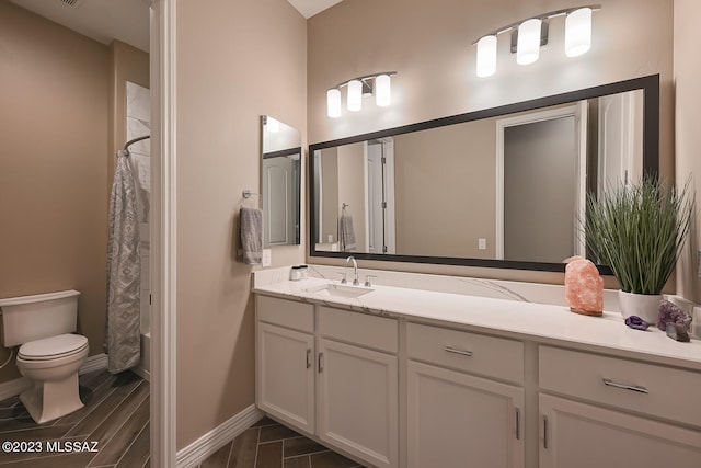 full bathroom with toilet, vanity, a shower with shower curtain, and baseboards