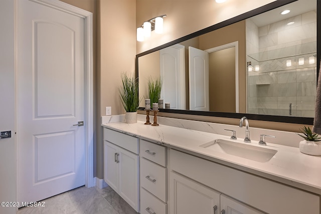 bathroom with marble finish floor, a stall shower, and vanity