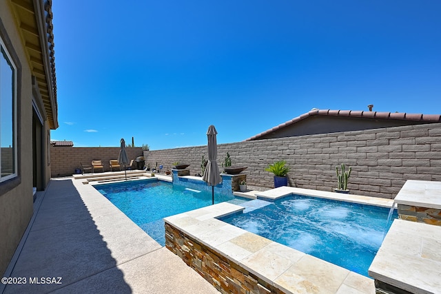 view of pool with a fenced in pool, an in ground hot tub, and a fenced backyard