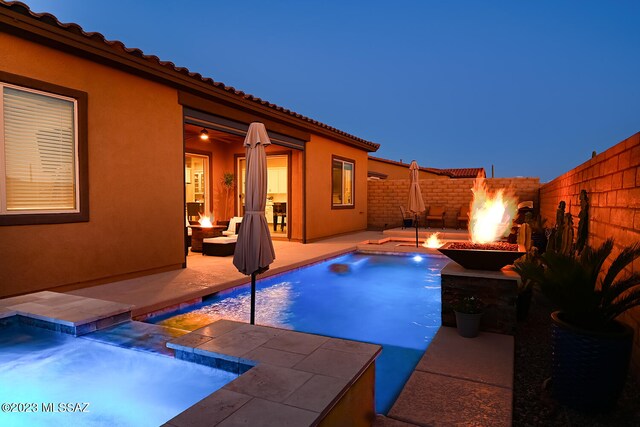 view of swimming pool featuring a patio area, a fire pit, and a fenced backyard