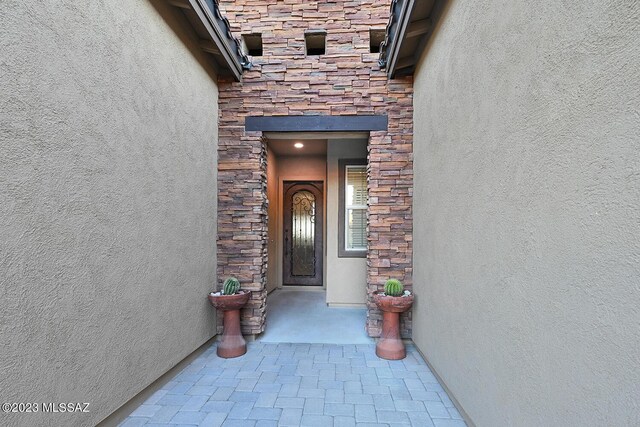 entrance foyer featuring crown molding, a barn door, a tray ceiling, and parquet floors