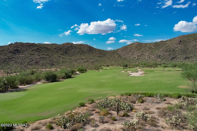 view of home's community with a mountain view and view of golf course