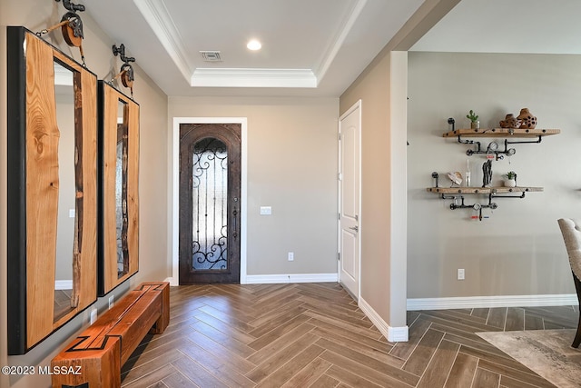 entrance foyer with visible vents, crown molding, baseboards, a tray ceiling, and recessed lighting