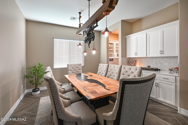 dining space with parquet floors, baseboards, and visible vents