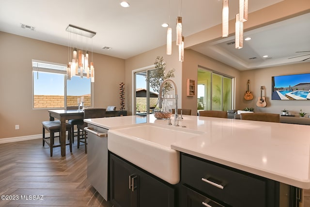 kitchen featuring a sink, dark cabinetry, recessed lighting, light countertops, and dishwasher