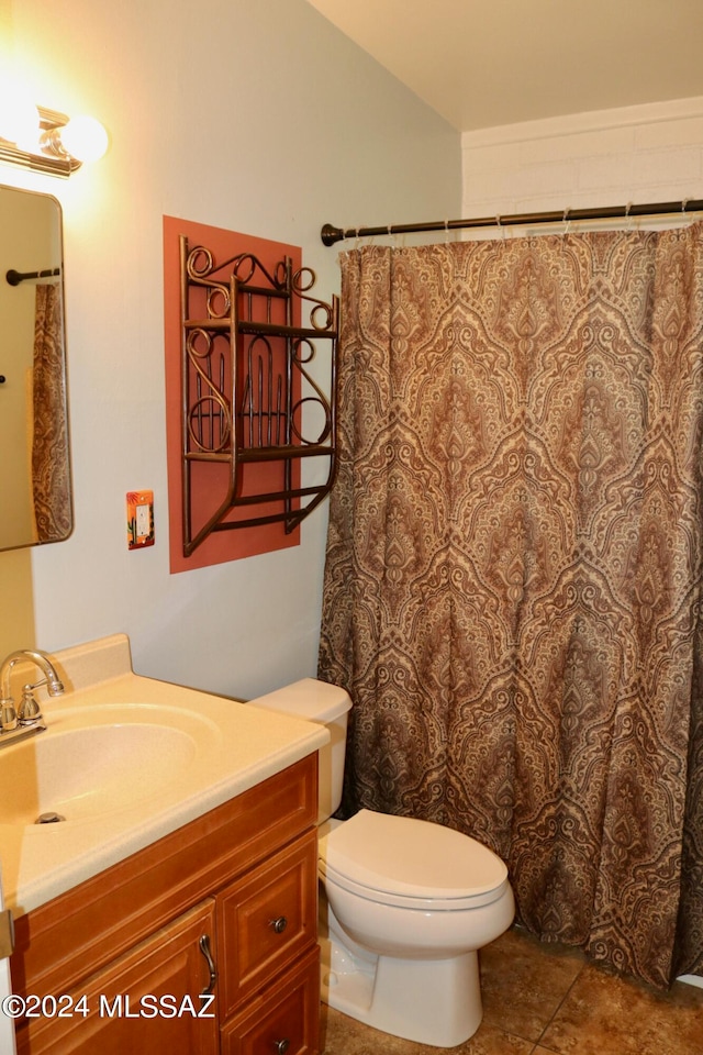 bathroom featuring tile patterned floors, vanity, and toilet