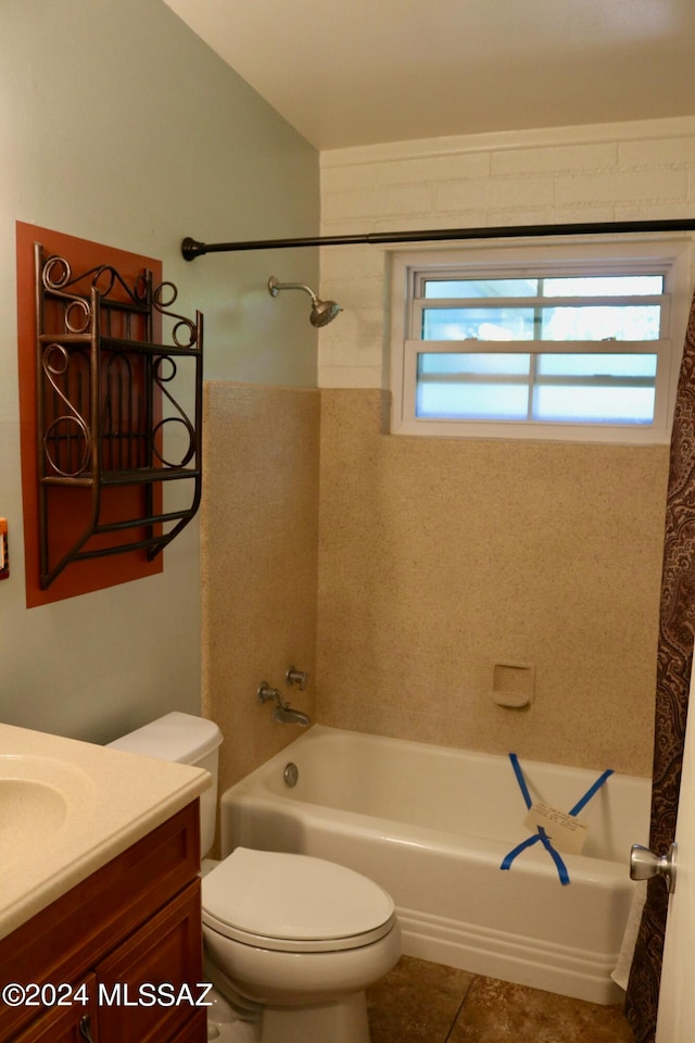 full bathroom with toilet, tiled shower / bath combo, vanity, and tile patterned flooring