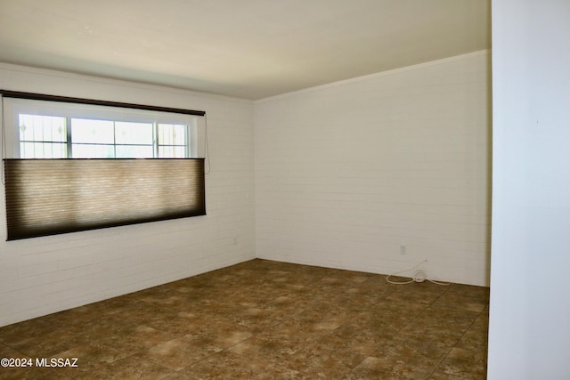 unfurnished room featuring dark tile patterned flooring