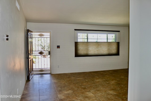 spare room featuring tile patterned flooring and a wealth of natural light