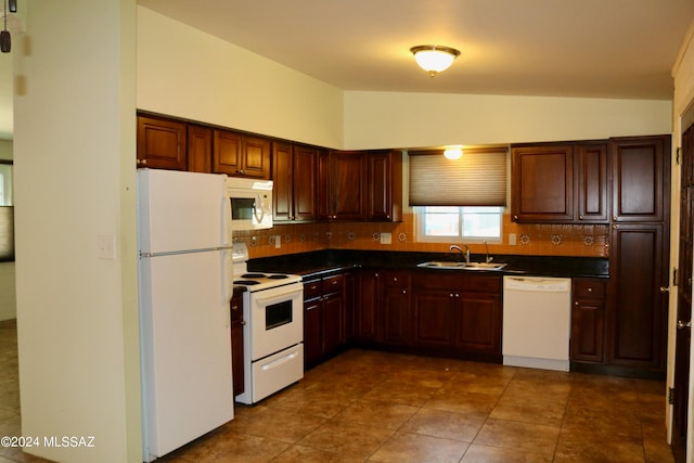 kitchen with white appliances, decorative backsplash, tile patterned floors, vaulted ceiling, and sink