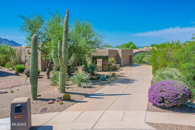 adobe home featuring a garage and a mountain view