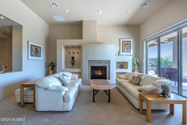 carpeted living room featuring a premium fireplace