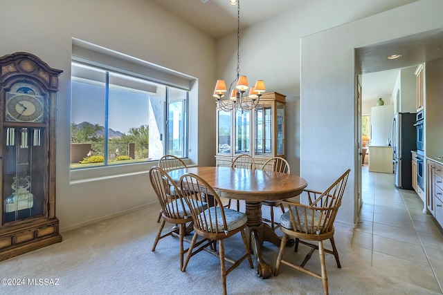 dining area featuring light tile patterned floors and a notable chandelier