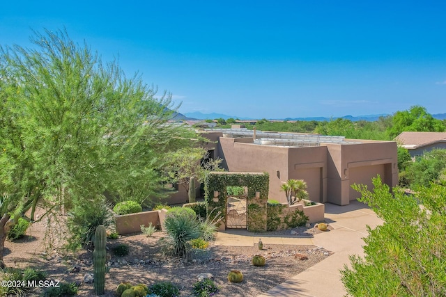 view of front facade featuring a garage and a mountain view