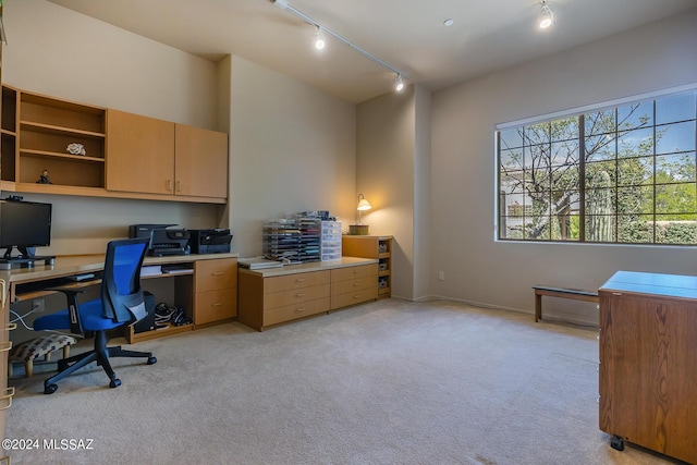 home office featuring light colored carpet and rail lighting