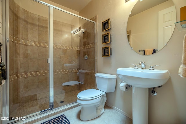 bathroom with a shower with shower door, tile patterned floors, and toilet