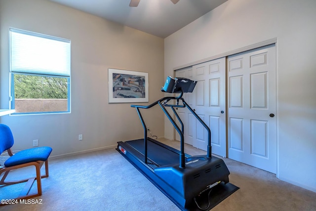 workout room featuring light colored carpet and ceiling fan