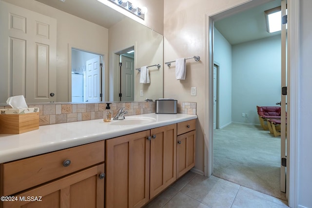 bathroom with vanity, backsplash, and tile patterned floors