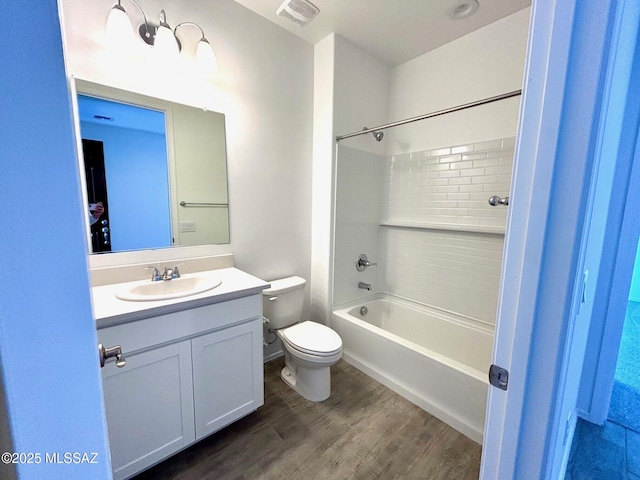 full bathroom with vanity, hardwood / wood-style floors, toilet, and washtub / shower combination