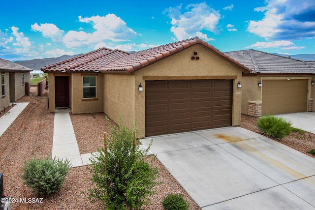 view of front of home featuring a garage and a mountain view