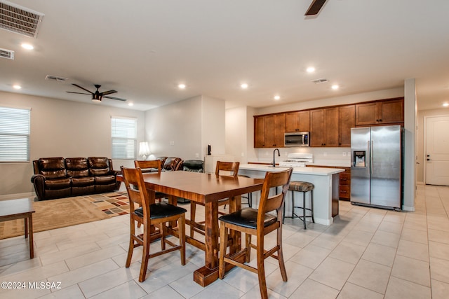 tiled dining area featuring ceiling fan