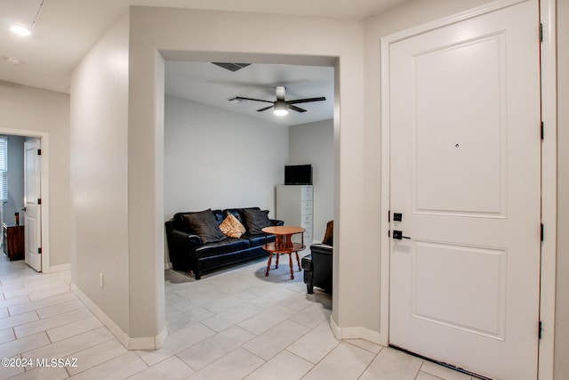 tiled living room featuring ceiling fan