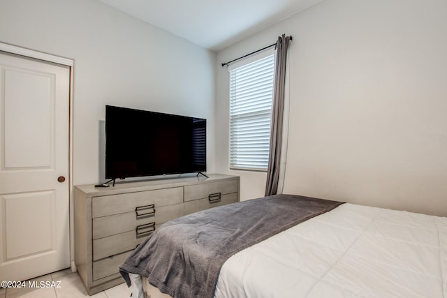 bedroom with light tile patterned floors