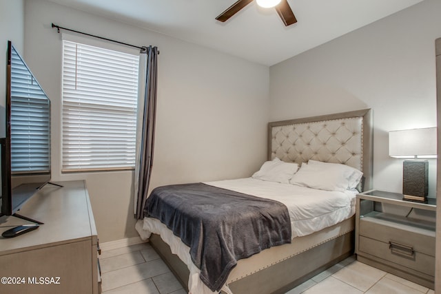 tiled bedroom with ceiling fan