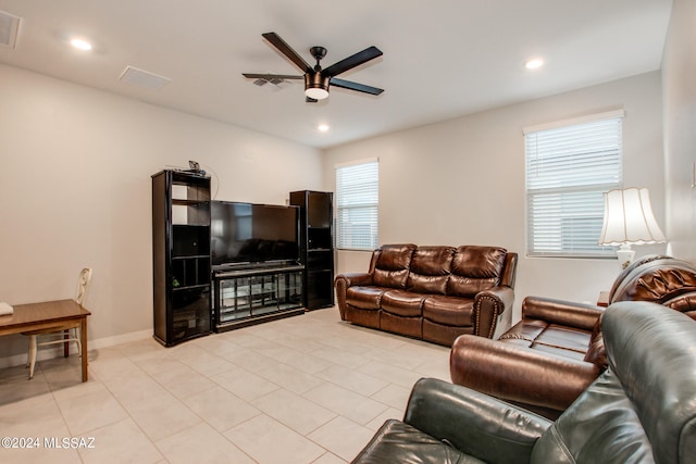 tiled living room with ceiling fan