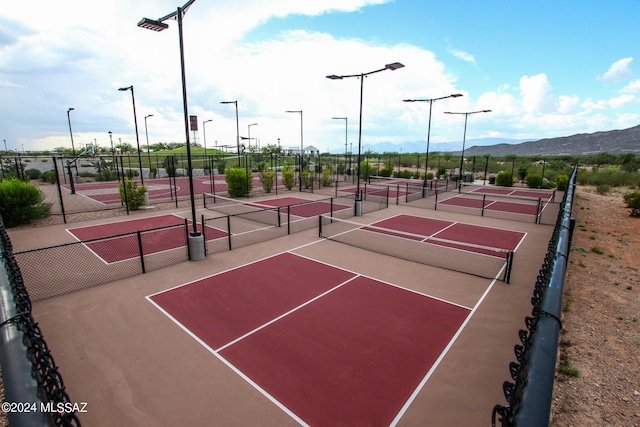 view of tennis court with a mountain view