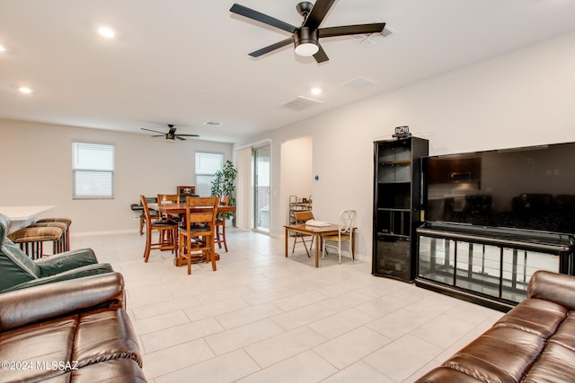 living room with light tile patterned flooring and ceiling fan