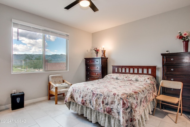 bedroom with light tile patterned floors and ceiling fan