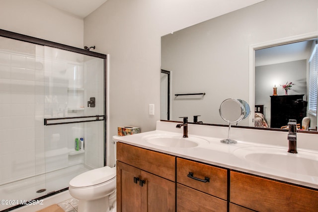 bathroom featuring toilet, an enclosed shower, tile patterned flooring, and dual bowl vanity