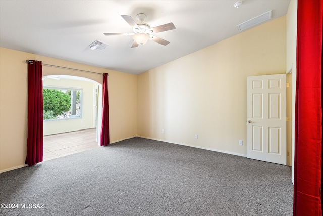 empty room with ceiling fan and light colored carpet