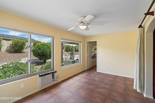 tiled empty room with ceiling fan and a wall mounted air conditioner