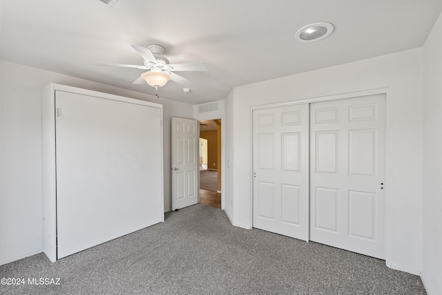 unfurnished bedroom featuring ceiling fan, a closet, and carpet floors