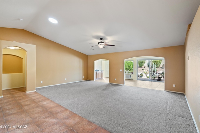 spare room with ceiling fan, light tile patterned floors, and lofted ceiling