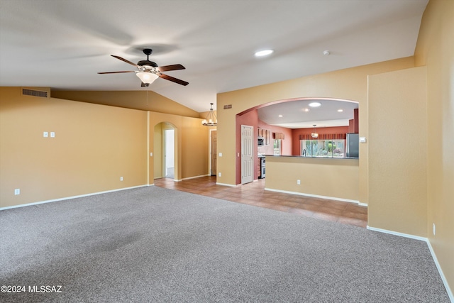 unfurnished living room featuring ceiling fan, lofted ceiling, and carpet