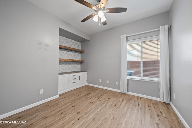 interior space with light wood-type flooring, ceiling fan, and a healthy amount of sunlight