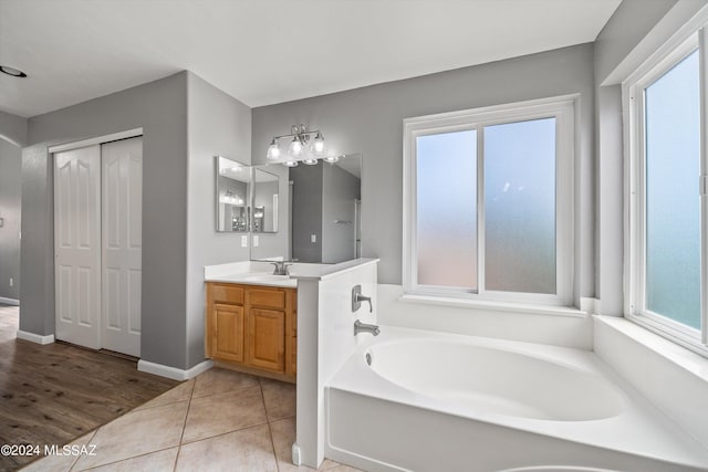 bathroom with vanity, tile patterned floors, and a bathing tub