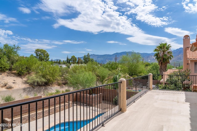 balcony featuring a mountain view and a patio