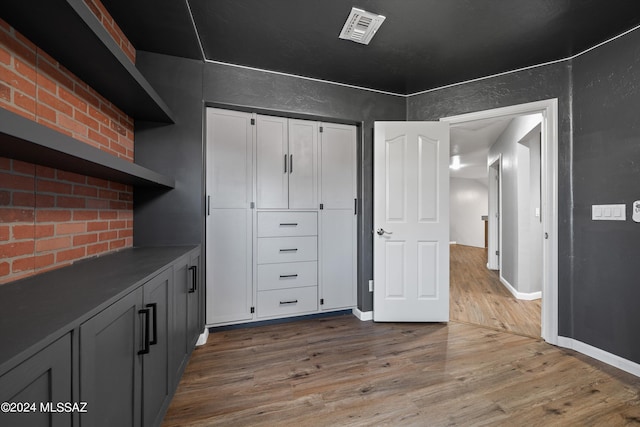 interior space with wood-type flooring and gray cabinets