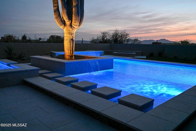 2155 E Desert Garden Dr, Tucson, AZ 85718 - pool at dusk featuring a fenced in pool and a jacuzzi