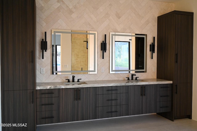 2155 E Desert Garden Dr, Tucson, AZ 85718 - bathroom with double vanity, a sink, and tasteful backsplash