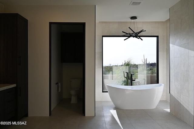 2155 E Desert Garden Dr, Tucson, AZ 85718 - full bathroom with tile patterned floors, a freestanding bath, visible vents, and toilet