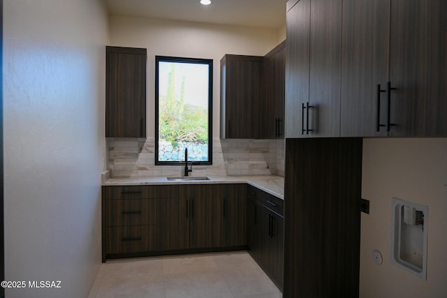 2155 E Desert Garden Dr, Tucson, AZ 85718 - kitchen with modern cabinets, a sink, light tile patterned floors, and tasteful backsplash