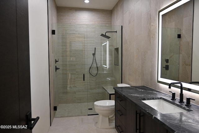 2155 E Desert Garden Dr, Tucson, AZ 85718 - bathroom with vanity, tile walls, toilet, a shower stall, and tile patterned floors