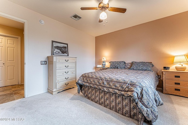 carpeted bedroom with visible vents, ceiling fan, and baseboards